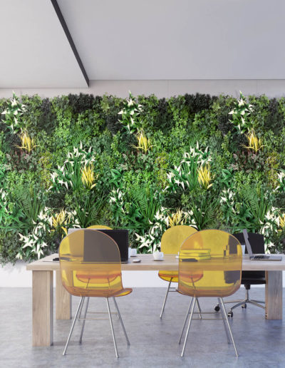 Office with plant wall and yellow desk chairs